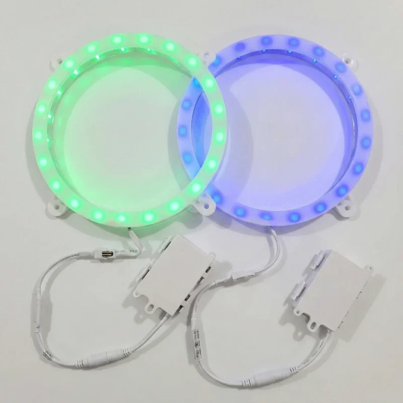 Close-up of wooden board with illuminated blue LED Cornhole lights ring installed in 6-inch hole glowing at night. Close-up of wooden board with illuminated blue LED Cornhole lights ring installed in 6-inch hole glowing at night.