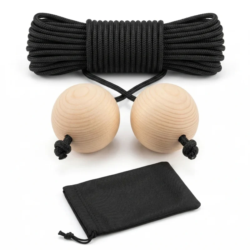 A premium Cornhole distance cord featuring smooth pine wood balls and a durable nylon rope, lying next to a black drawstring storage bag for regulation 27-foot setups.