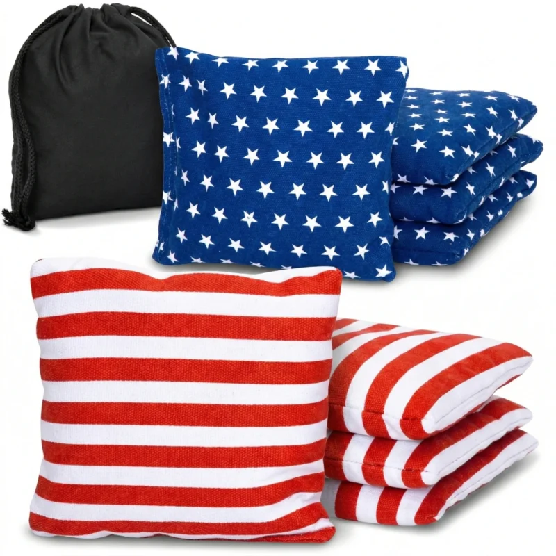 Set of 8 red and blue Cornhole bags regulation size made of durable duck canvas stacked next to a black drawstring carry tote for wholesale catalog.